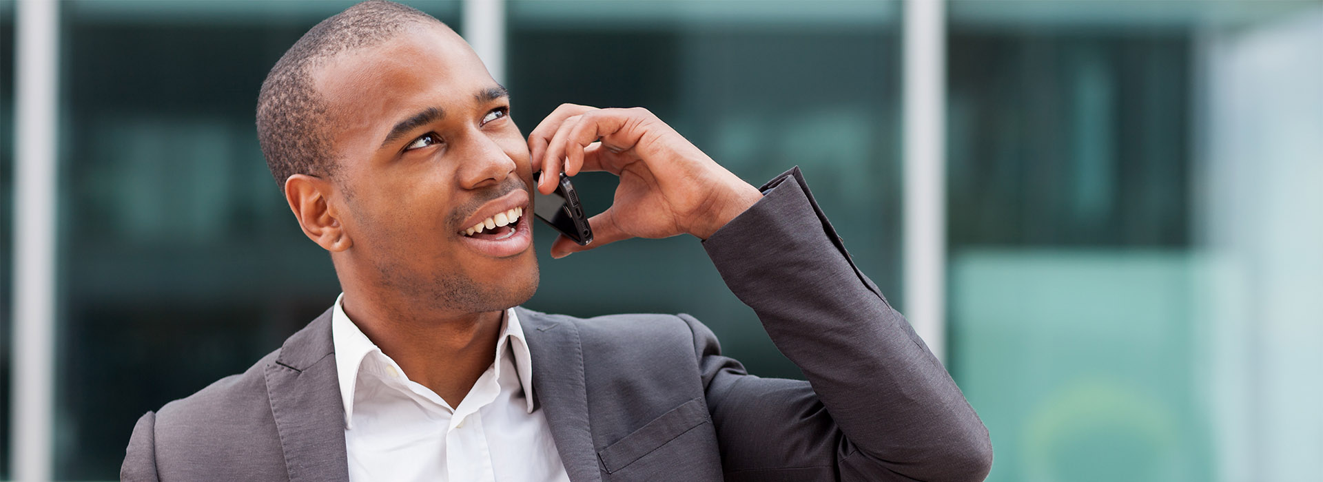 Afro American manager sitting on the bench and phoning